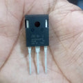 GWT80H65DFB MOSFET Transistor - a black three-pin electronic component held in a palm, with STMicroelectronics branding and text printed on its surface.