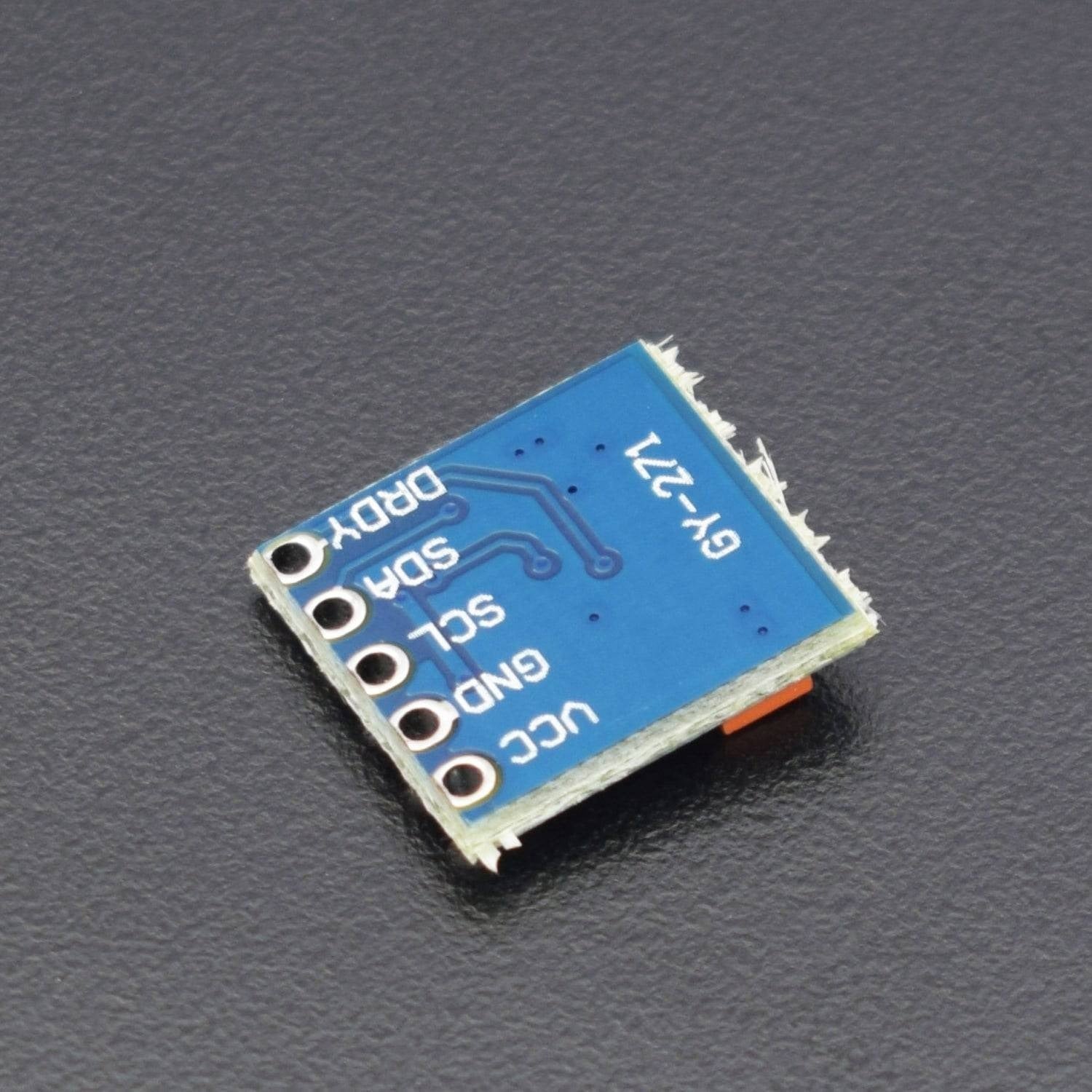 Gy 271 3-axis Magnetic Electronic Compass Module - a small square blue circuit board with five labeled pin holes: VCC, GND, SCL, SDA, and DRDY.