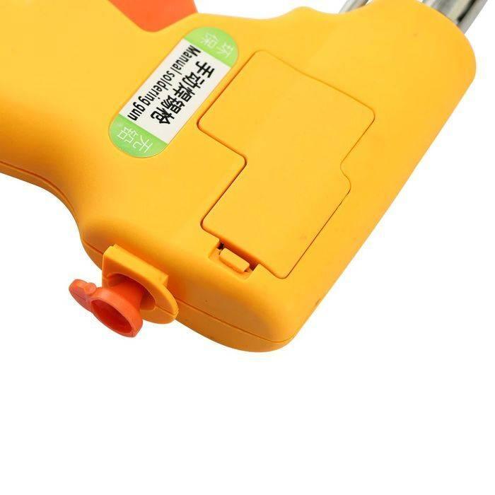 Hand-held Heating Soldering Iron 110V / 220V 60W / 80W mannual Soldering gun - a close-up of the yellow, pistol-grip handle showing a label with Chinese text and the English words Manual soldering gun.