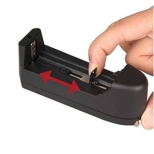 Handheld Focusable Green Laser Pen Zh 303 Rechargeable 100mW High Beam Green Laser Hunting Pointer - a black plastic battery charger with a sliding spring-loaded contact being adjusted by a finger.