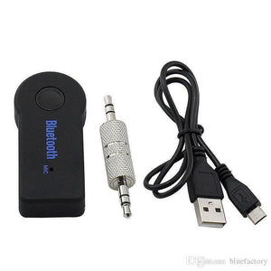Handsfree Wireless Audio Car Bluetooth Music Receiver Adapter - a black receiver with a button, a 3.5mm audio adapter, and a USB charging cable.