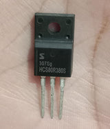 HCS80R380S 800V N-Channel Super Junction MOSFET (TO-220FS) Used - a black TO-220FS package electronic component with three metal pins, shown in a close-up view held against a palm.