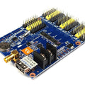 HD-W63 WiFi + USB Asynchronous LED Control Card - a blue circuit board featuring multiple yellow pin headers, a USB port, antenna connector, and terminals.
