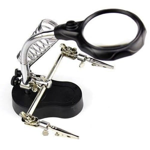Helping Hand Clip Desktop LED Light Magnifier Glass With Soldering Stand 3.5x 12x - a black base, two adjustable metal alligator clips, and a magnifier.
