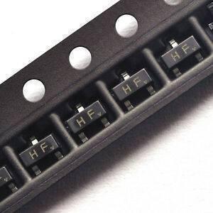 Hf SMD NPN, 15V, 0,1A, 0,5W, Sot-23 - a close-up view of multiple black SOT-23 components labeled "HF" arranged in a plastic carrier tape strip.
