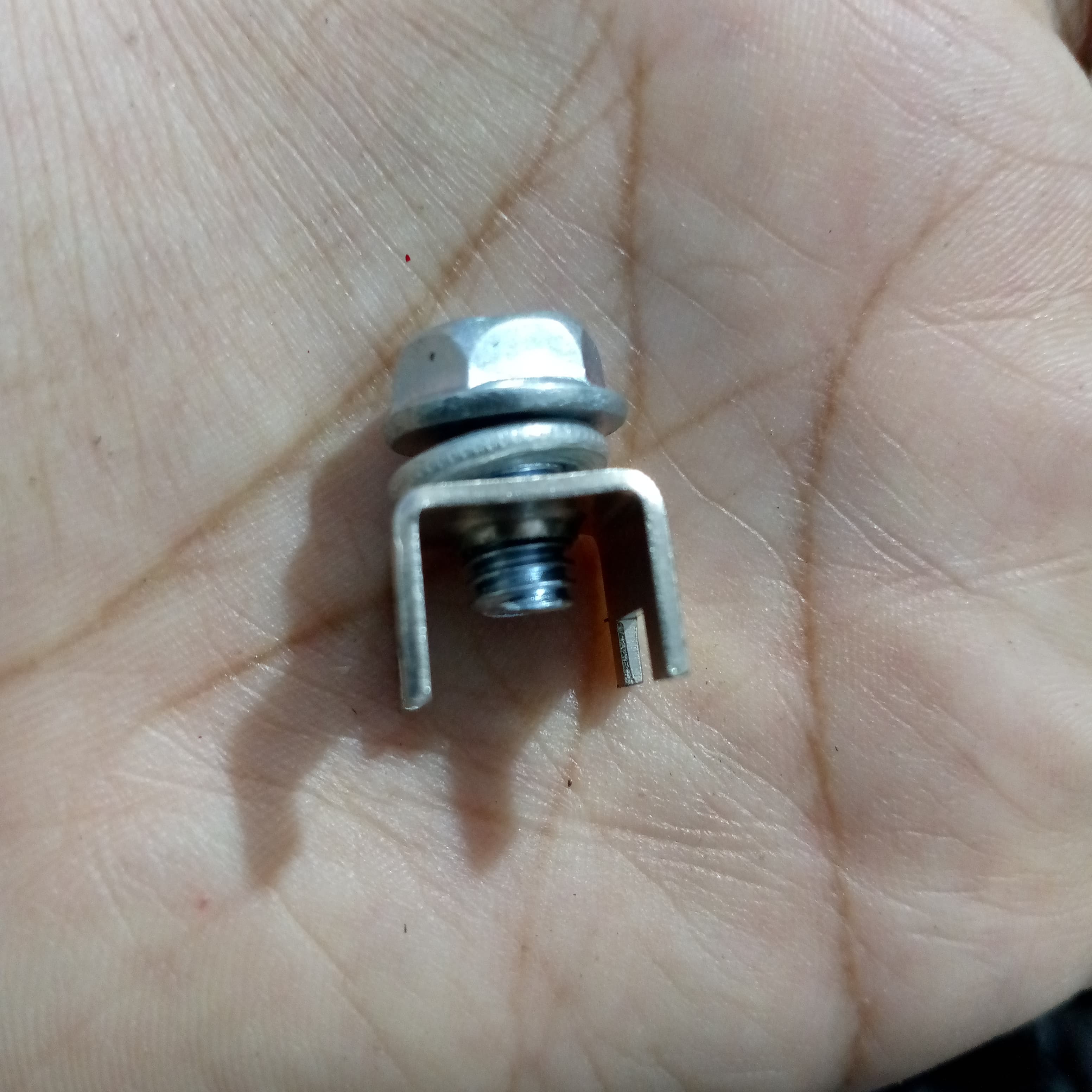 High Current Screw Terminal Connector - a close-up showing a silver metal U-shaped bracket with a bolt, washer, and nut held in a palm.