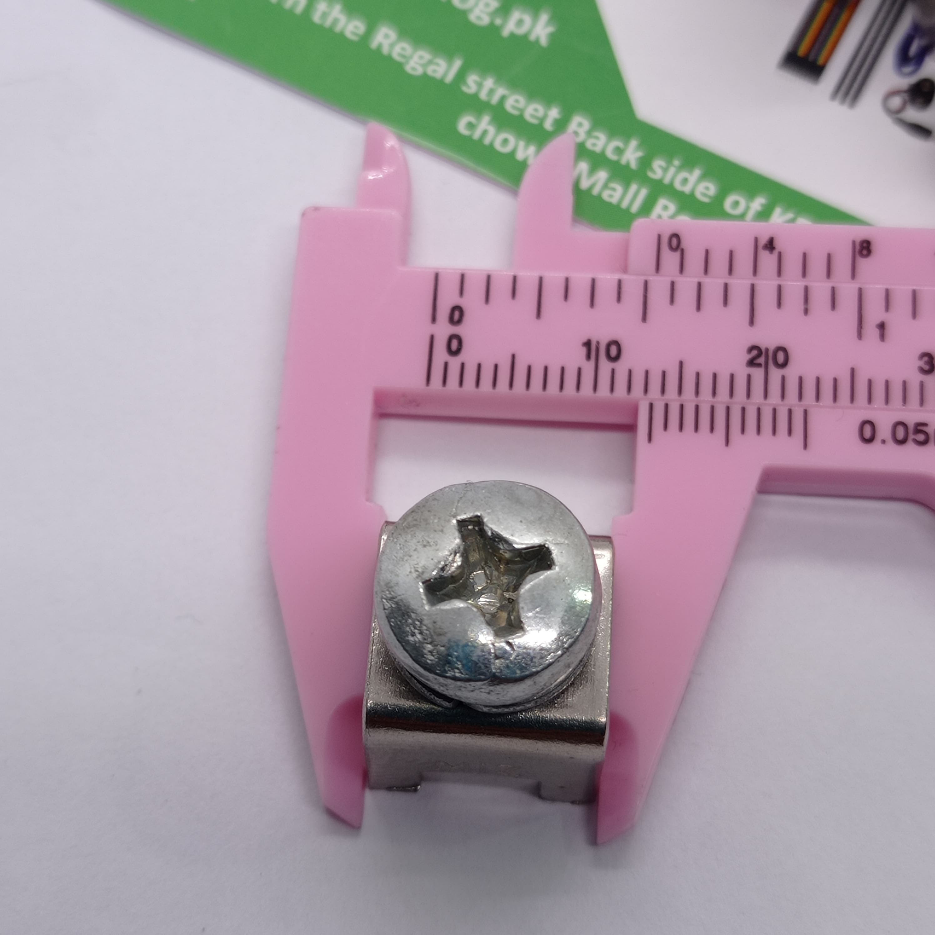 High Current Screw Terminal Connector - shown in a close-up view being measured by pink plastic calipers, with the zero mark at the 8mm position.