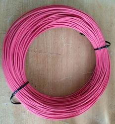 High quality Red wire 1 meter - shown as a coiled length of red electrical wire secured by two black cable ties on a wooden surface.