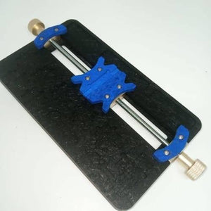 High Temperature PCB Board Holder Maintenance Repair Fixture Stand For Mobile Phone SMT Soldering Iron - a black rectangular base with a central threaded rod and blue sliding clamps.