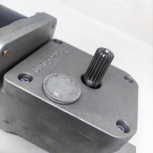High Torque Gear Motor For Electric Bicycle Electric Cycle Electric Bike Price - a close-up showing the metallic gear housing, a splined output shaft, and a Pakistani coin for scale.