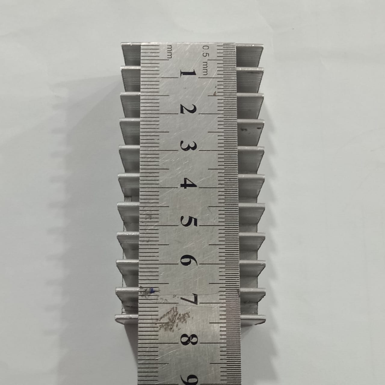 Hot Aluminum Alloy Heatsink Cooling Pad For High Power LED IC Chip Cooler Radiator Heat Sink For LED COB Light - shown from a top-down view with a metal ruler placed over it to display its dimensions in centimeters.