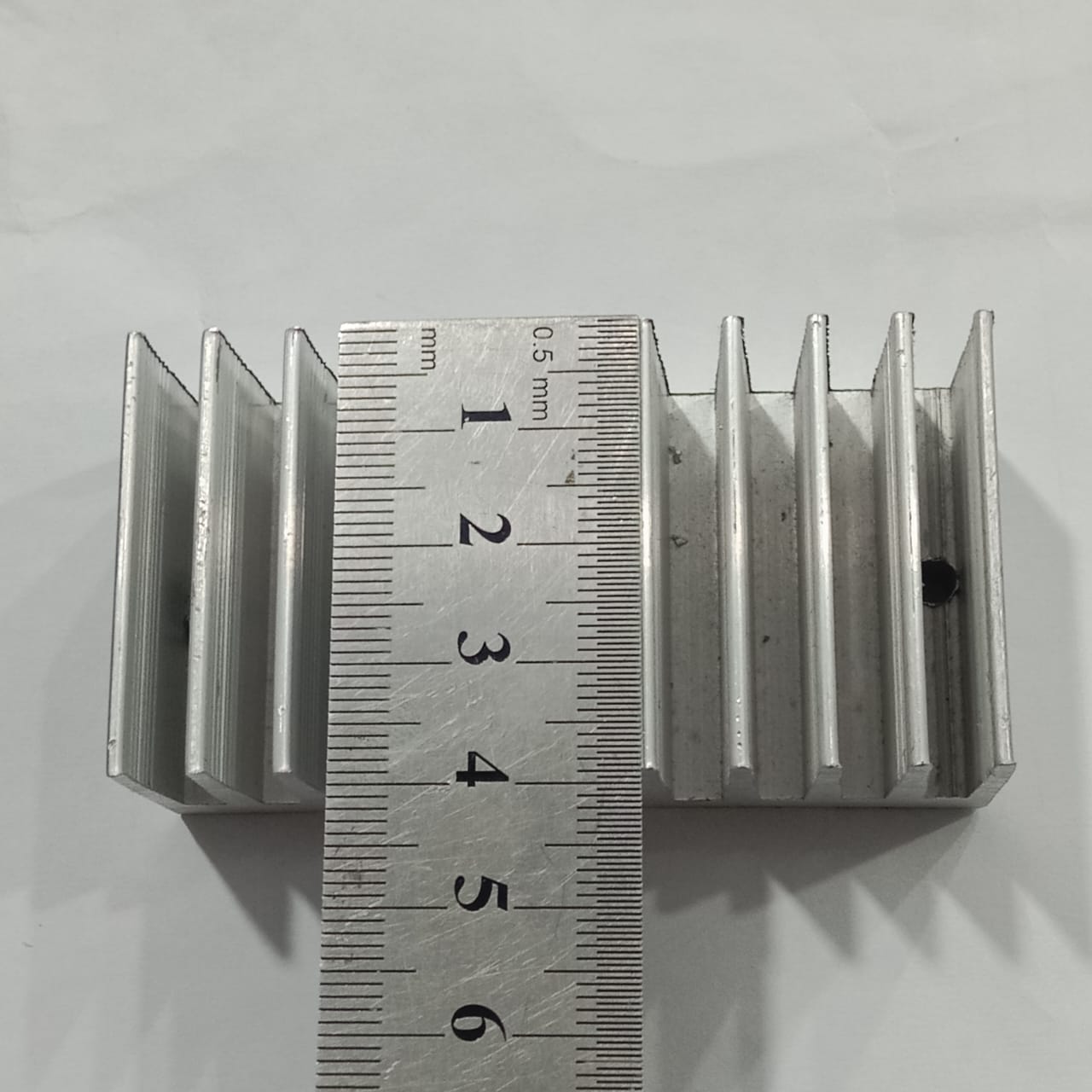 Hot Aluminum Alloy Heatsink Cooling Pad For High Power LED IC Chip Cooler Radiator Heat Sink For LED COB Light - shown with a metal ruler measuring its length, which is approximately 5.5 centimeters.