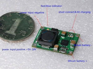 Hw-370 TP5100 2A Li Ion Battery Charger Module - a green circuit board with a black inductor, labeled solder pads, and a coin for scale.