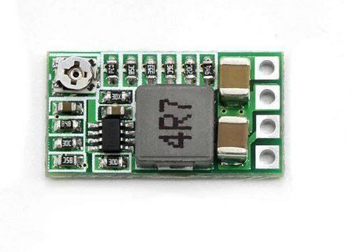 Hw-613 Adjustable DC To DC Buck Converter Module 3A - a small green rectangular circuit board featuring a silver potentiometer, a grey inductor, and capacitors.