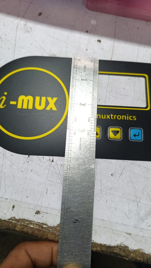 Hybride LCD Sticker Idm-7 Sticker For Graphical LCD Based Local Solar Inverter - a black rectangular overlay with yellow text, a screen cutout, and three buttons, measured by a metal ruler.