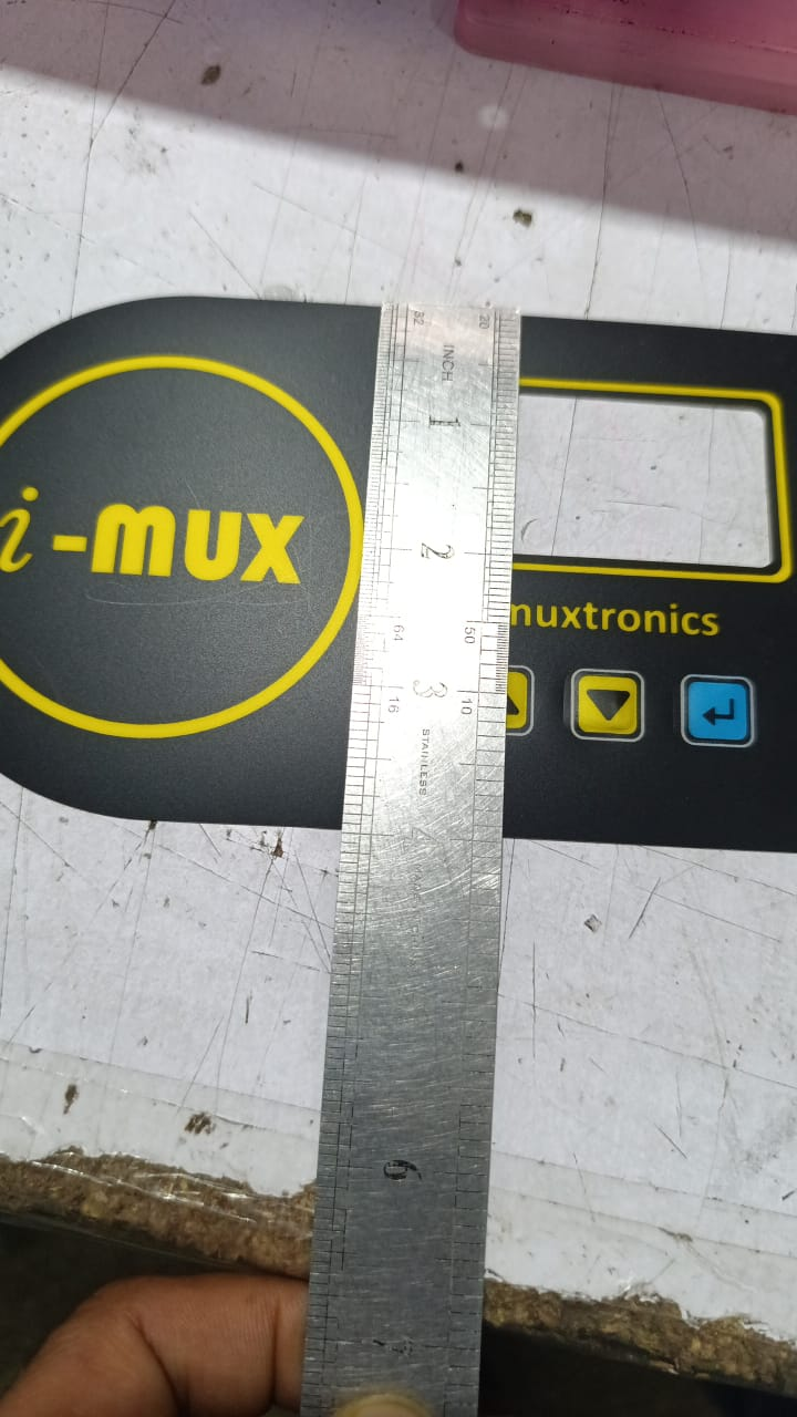 Hybride LCD Sticker Idm-7 Sticker For Graphical LCD Based Local Solar Inverter - a black rectangular overlay with yellow text, a screen cutout, and three buttons, measured by a metal ruler.