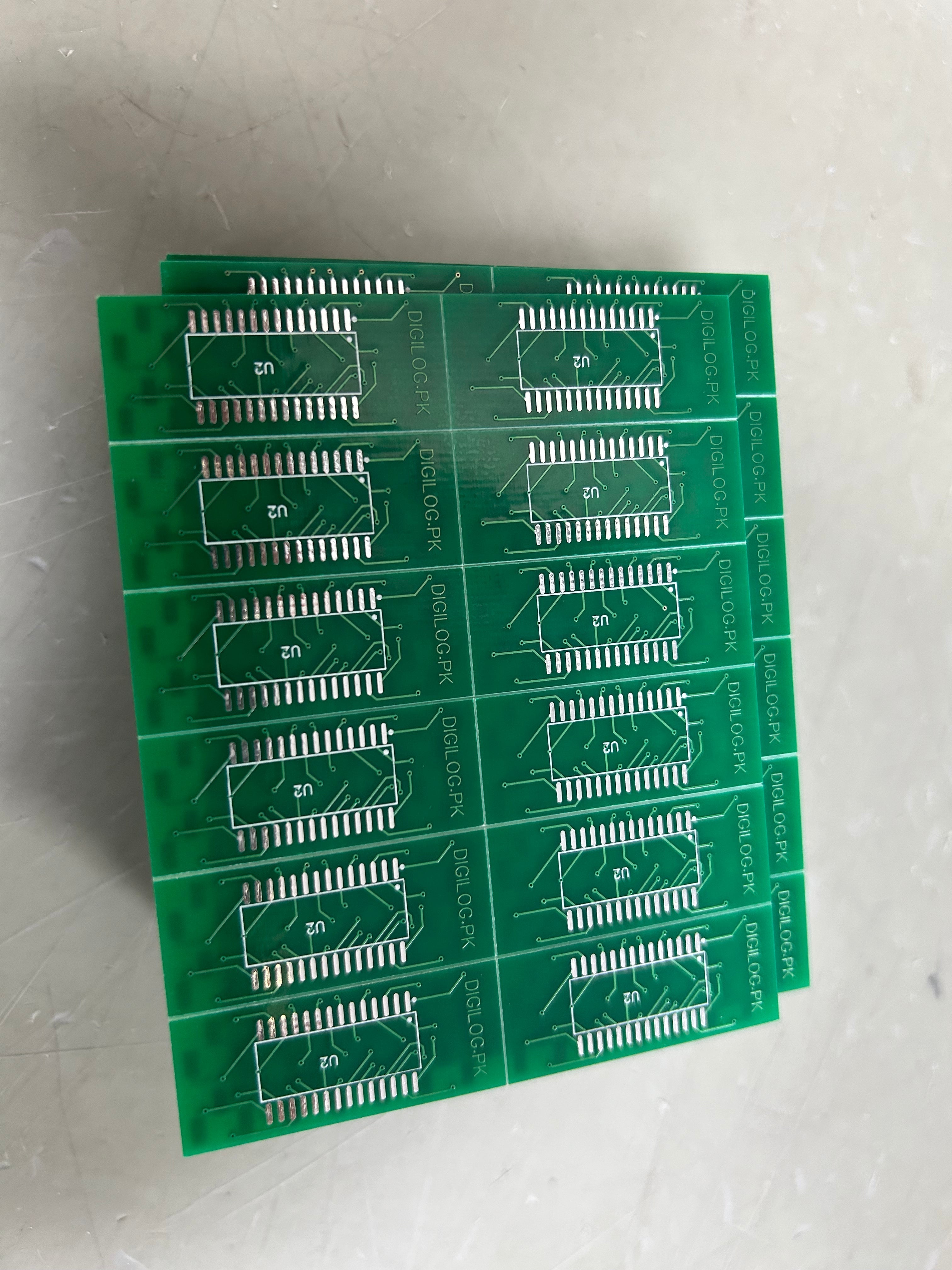 IC Base With Header SMD DSPIC30F2010 - a stack of green printed circuit board panels, each featuring multiple SMD IC footprints labeled U2.
