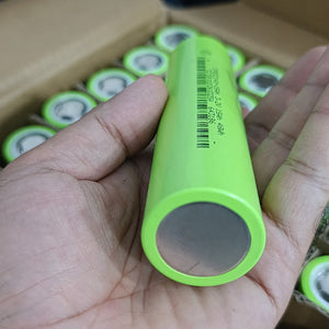 IFR32140 LiFePO4 Battery Cell 3.2V 15Ah 15A - Grade A Fresh Stock - a close-up of a light green cylindrical battery held in a hand, showing printed text and a barcode on its side.