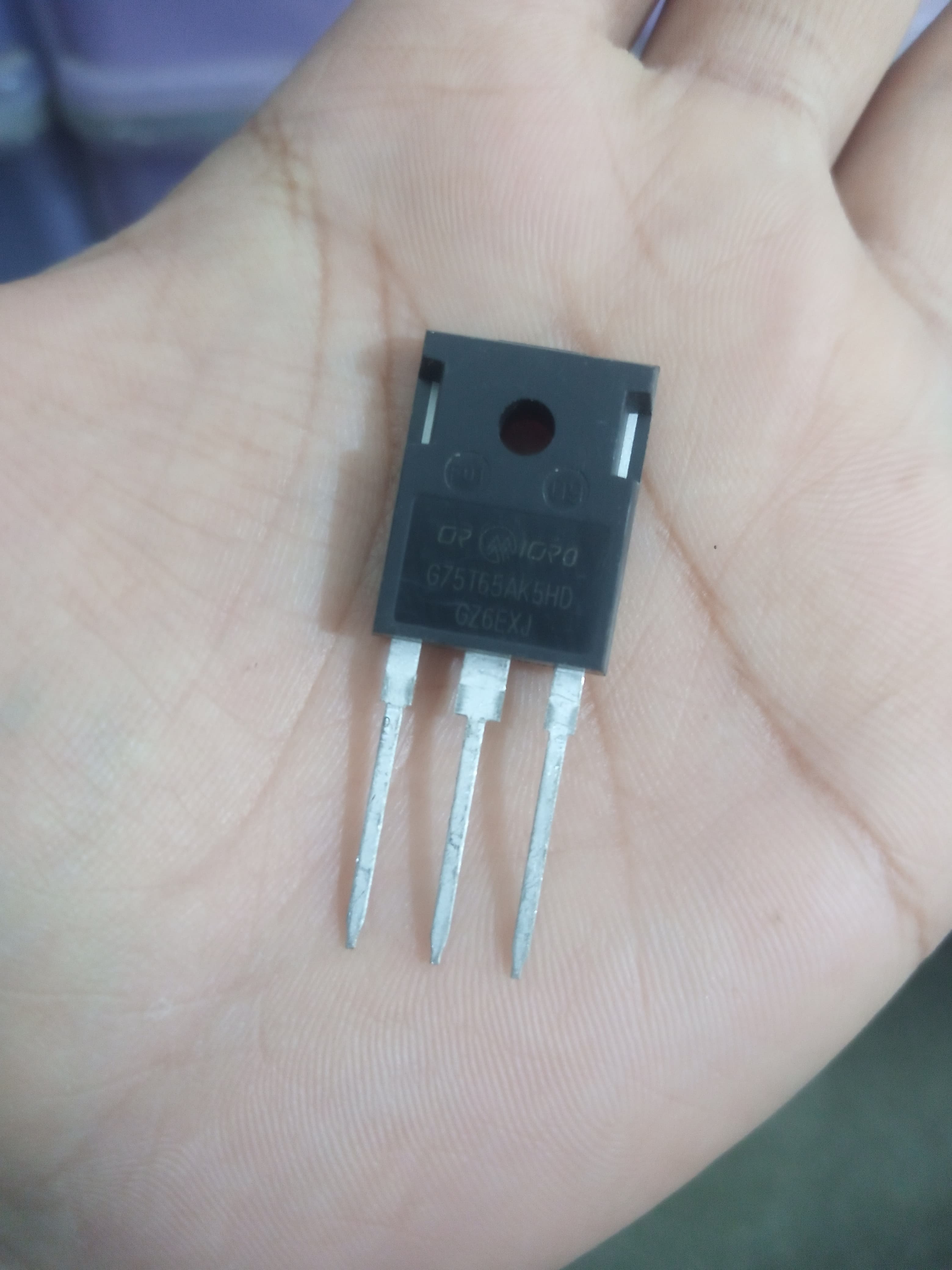 IGBT G75T65AK5HD - High-power Insulated Gate Transistor - a black three-pin transistor component held in a palm, showing the model number printed on the front surface.