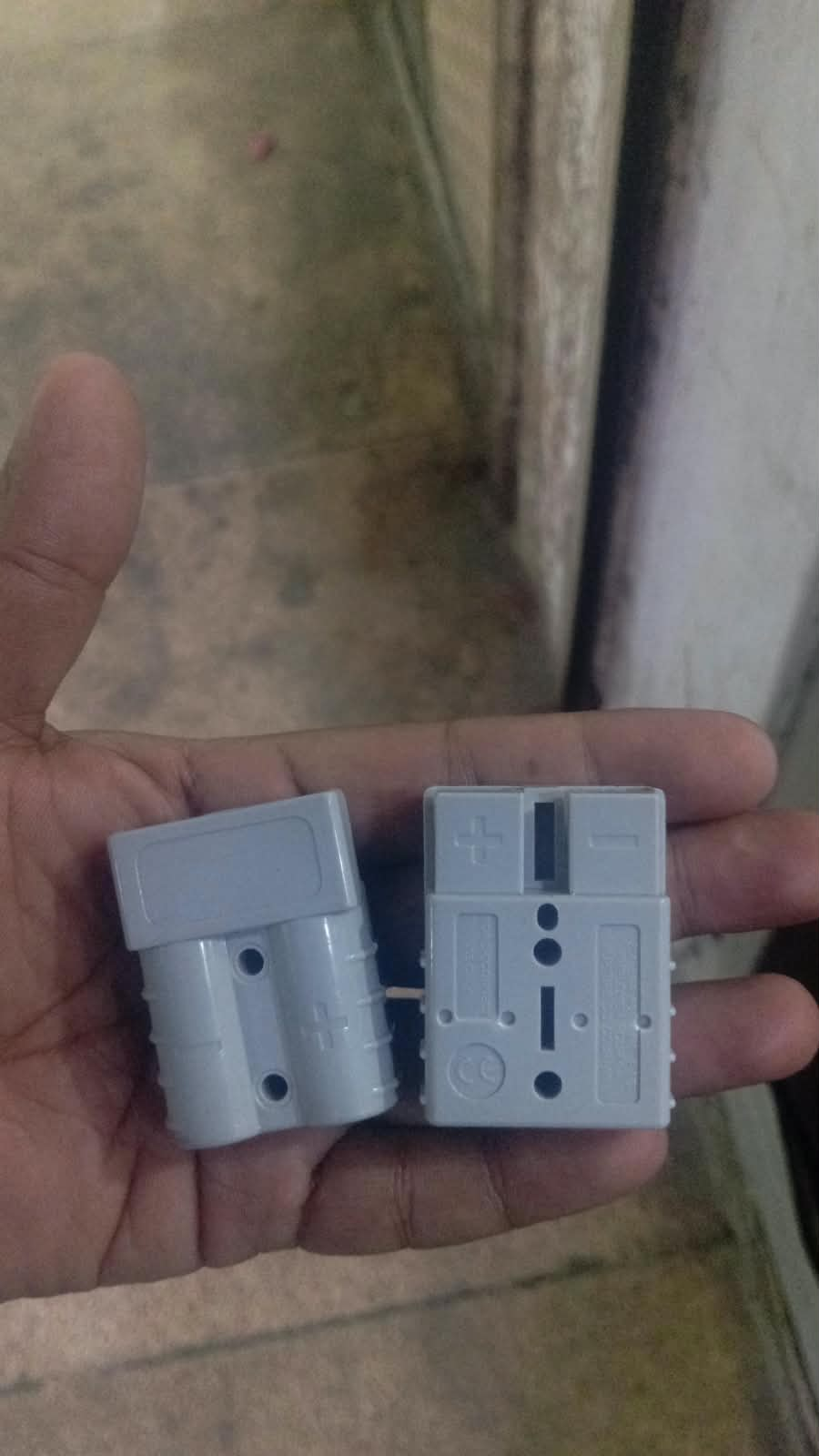 Grey battery connector housings shown from two angles