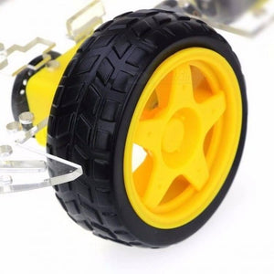 Imported Original 4wd Smart Robot Car Chassis Kit For Arduino - a close-up showing a black rubber tire on a yellow five-spoke wheel attached to the frame.