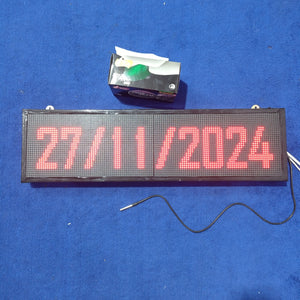 Industrial Clock With Temperature Display RGB Display - the date 27/11/2024 on its screen, with a temperature sensor probe and a tissue box nearby.