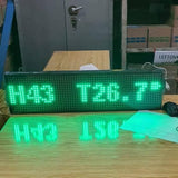 Industrial Grade 8 inch x 26inch Digital Hygrometer Display - green LED text reading H43 T26.7 on a wooden desk with a computer mouse nearby.