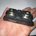 Industrial Solid State Relay DC Control AC Ssr MGR-H3200Z - a black rectangular body with two large screw terminals and an LED.
