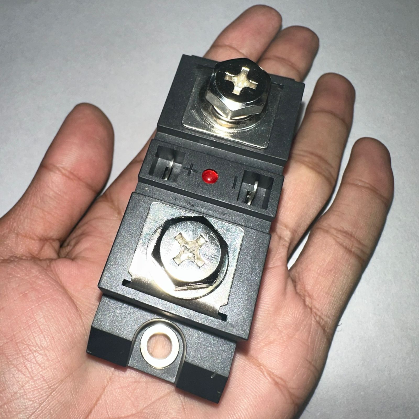 Industrial Solid State Relay DC Control AC Ssr MGR-H3200Z - shown held in a palm, featuring two large screw terminals and a central red LED indicator.