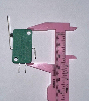 Industrial Switches Micro Switch Spdt Momentary Travel Limit Switch 1NO1NC Lever Switches - shown with a green body and metal lever being measured by a pink plastic vernier caliper on a white background.