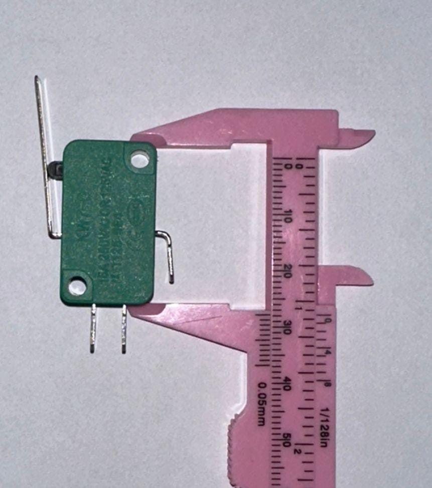 Industrial Switches Micro Switch Spdt Momentary Travel Limit Switch 1NO1NC Lever Switches - shown with a green body and metal lever being measured by a pink plastic vernier caliper on a white background.