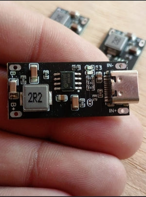 IP2312 Type C USB C Input High Current 3A 5V To 4.2V 4.35V Polymer Ternary Lithium Battery Fast Charging Board Type C USB C Input High Current 3A 5V - a close-up of a black rectangular circuit board with a USB-C port, a 2R2 inductor, and B+/B- solder pads.