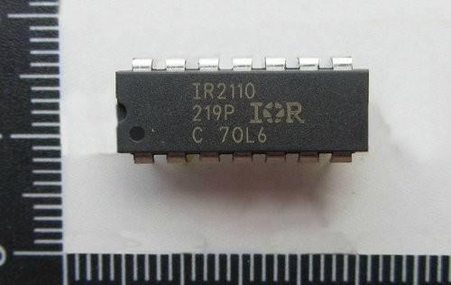 IR2110 MOSFET And IGBT Driver IC | Digilog.pk - a black rectangular 14-pin integrated circuit chip with white text markings, shown against a ruler for scale.