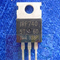 IRF740 n Channel Power MOSFET - a black, three-pin electronic component with a metal heat sink tab, shown in a close-up against a blue textured background.