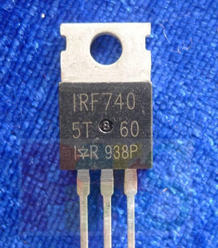 IRF740 n Channel Power MOSFET - a black, three-pin electronic component with a metal heat sink tab, shown in a close-up against a blue textured background.
