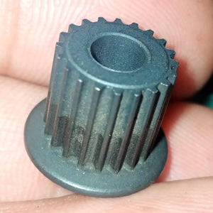 Japanese GT2 20 Teeth 5mm Bore Push Fit Pulley Timing Pulley - a close-up view of the black, cylindrical, toothed gear held between fingers.