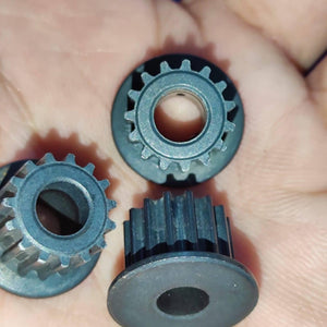 Japanese GT2 3mm Teeth Size 15 Teeth 6.3mm Bore Push Fit Pulley Timing Pulley - a close-up of three black, circular timing pulleys held in a hand.