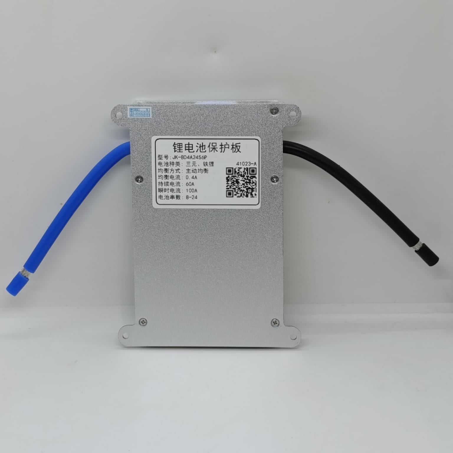 Jk 24S 60A Smart BMS With 400mA - a silver rectangular battery protection board with a central label, a QR code, and two thick wires extending from sides.