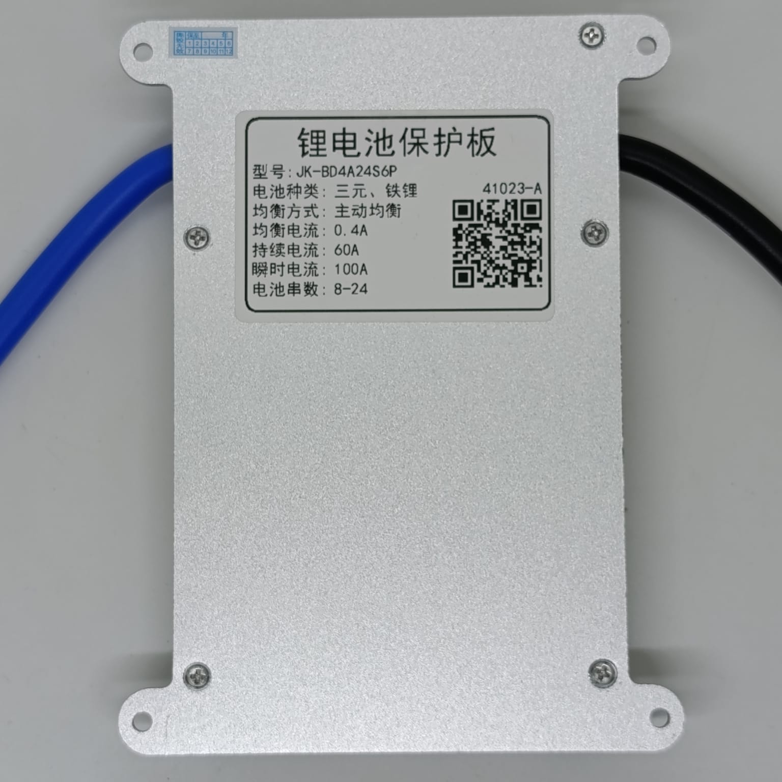 Jk 24S 60A Smart BMS With 400mA - a rectangular silver metal battery protection board with a white label displaying technical specifications and a QR code.