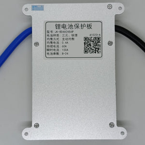 Jk 24S 60A Smart BMS With 400mA - a rectangular silver metal battery protection board with a white label displaying technical specifications and a QR code.