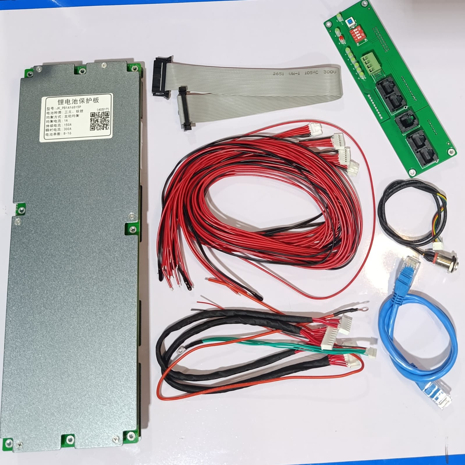 Jkbms PB1A16S15P Smart Inverter BMS 8s - 16S 24V 48V 150A Family Energy Storage LiFePO4/li-ion/lto - a silver rectangular control unit, a green circuit board with ports, ribbon cables, wiring, and connectors.