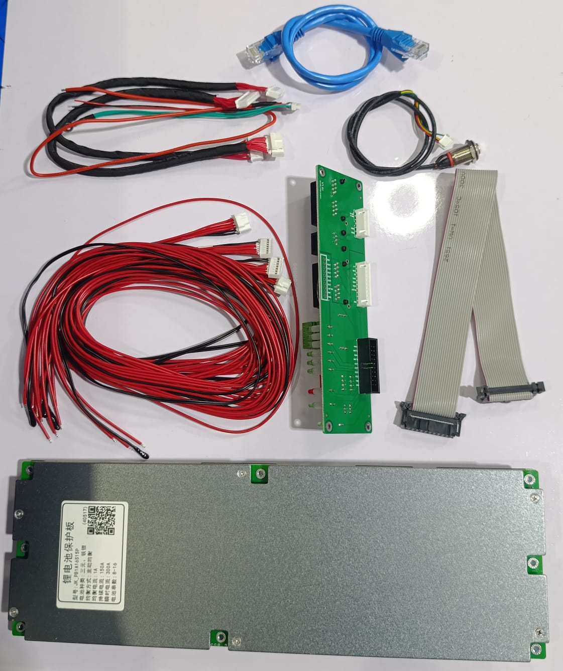 Jkbms PB1A16S15P Smart Inverter BMS 8s - 16S 24V 48V 150A Family Energy Storage LiFePO4/li-ion/lto - kit including a silver metal controller, green circuit board, wiring harnesses, ribbon cable, and ethernet cable.