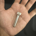 Kada 903D Tip Enclosure - a silver-coloured metal cylindrical sleeve with a knurled top cap, held in a person's palm.