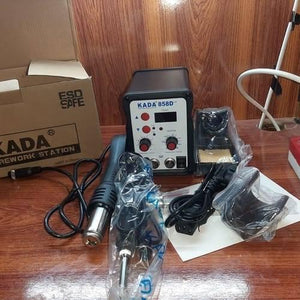 KADA858D+2 Kada 858D+2 Digital SMD Soldering Rework Station With Hot Air Gun And Soldering Iron - display, two control knobs, buttons, ports, a hot air gun, soldering iron, and accessories in a box.