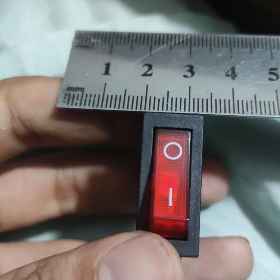 KCD3-104N Red Light 3pin Spst On And Off Rocker Switch - shown in a close-up view being measured by a metal ruler.