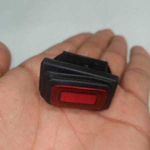 KCD3 Spdt Rocker Switch Waterproof - a black rectangular rocker switch with a red illuminated center, held in a person's palm.