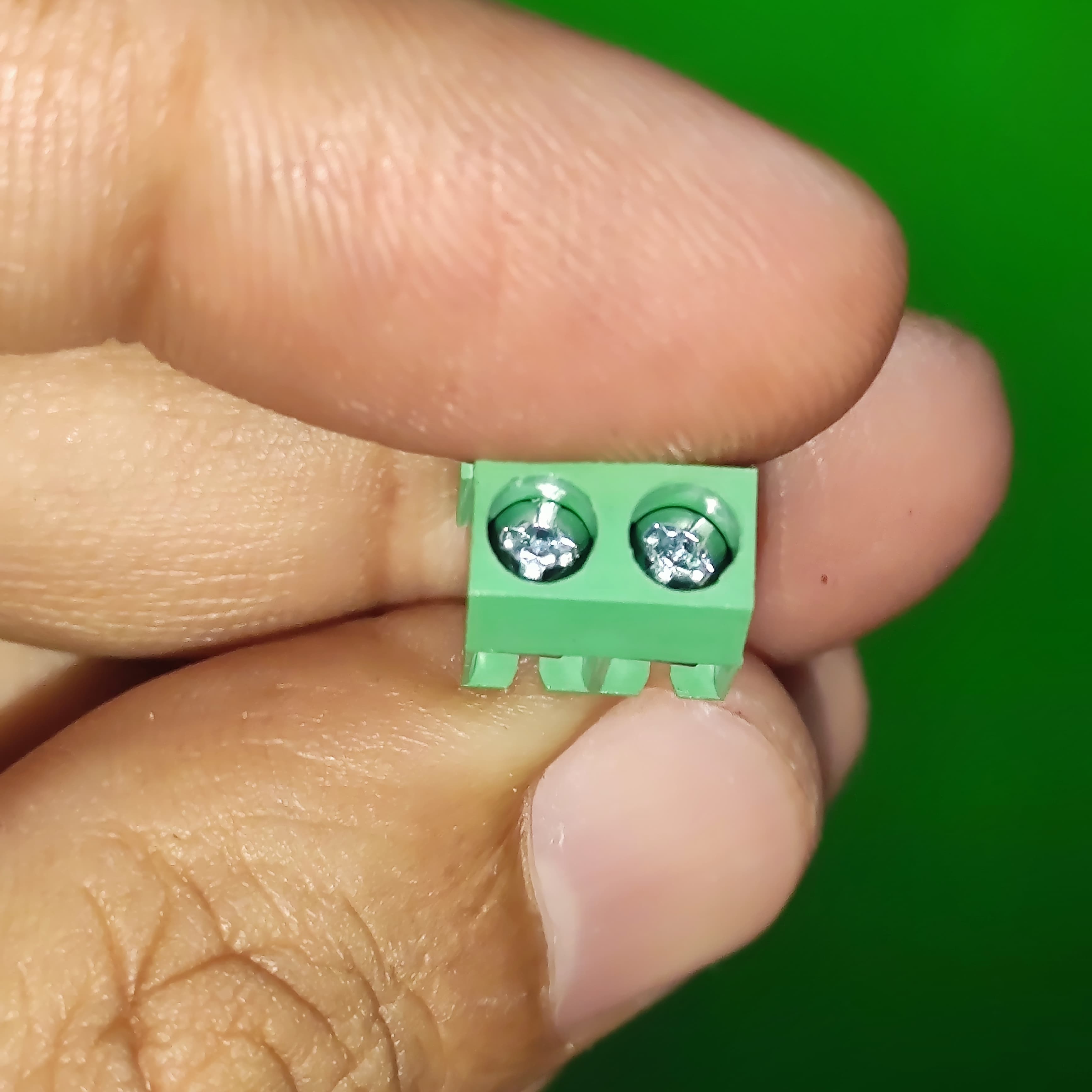Kf 350 /kf 126 250V 10A 5mm Pitch Green Color 2 Pin Screw Terminal Connector Tblock - a small green block with two metal screws held between fingers in a close-up view.