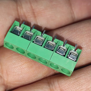 Kf 350 /kf 126 250V 10A 5mm Pitch Green Color 2 Pin Screw Terminal Connector Tblock - a 6-pin green screw terminal block held in a hand, showing the metal wire entry points and top screws.