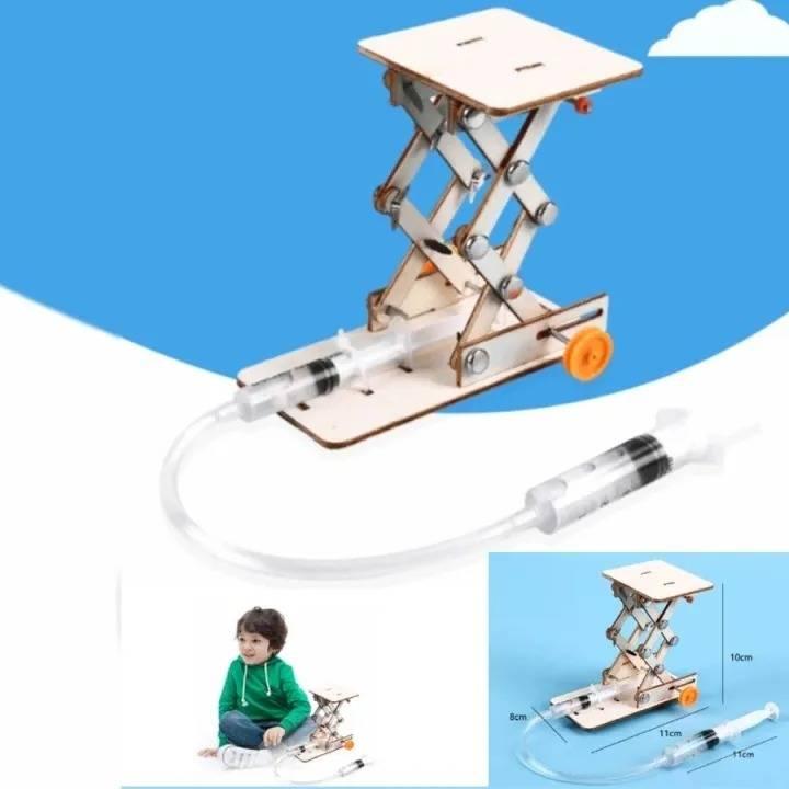 Kids DIY Hydraulic Lift Table Model Scientific Experiment Kit Educational STEM Toy - a wooden scissor lift mechanism connected by a clear tube to a syringe controller.