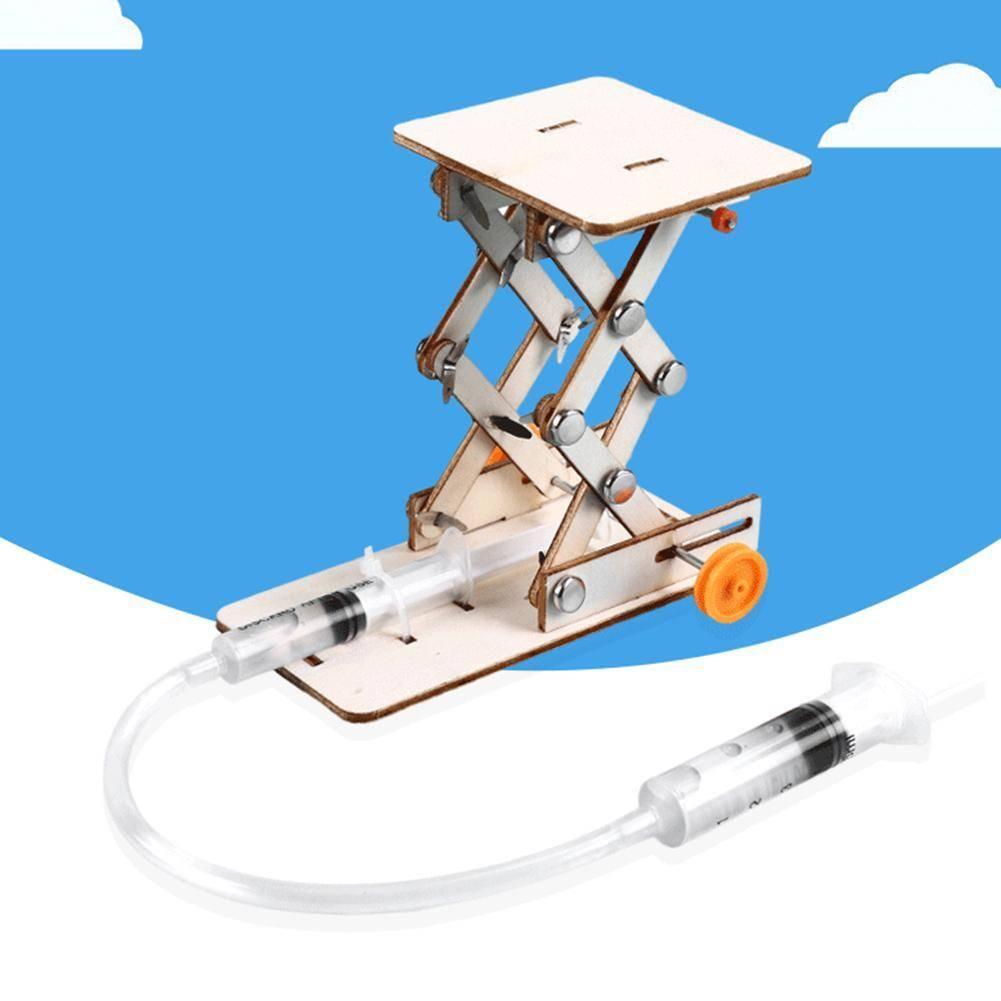 Kids DIY Hydraulic Lift Table Model Scientific Experiment Kit Educational STEM Toy - a wooden scissor lift mechanism connected by a plastic tube to a syringe, with a second syringe detached.